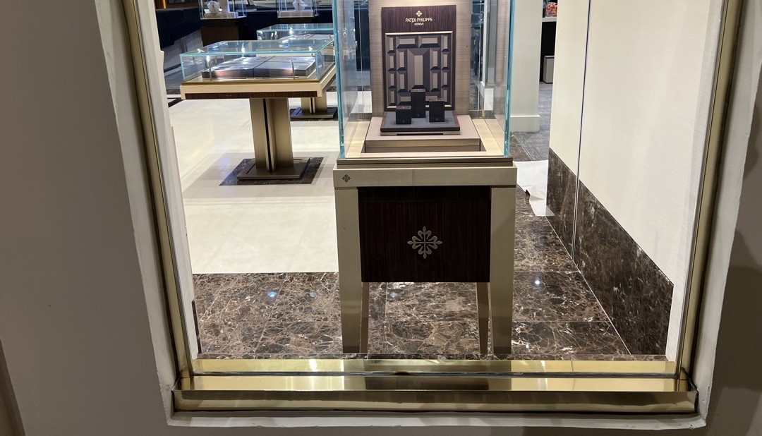 Luxury retail showroom electrical project featuring Rolex and Patek Philippe displays with custom chandelier lighting by Burlingame Brothers Electric