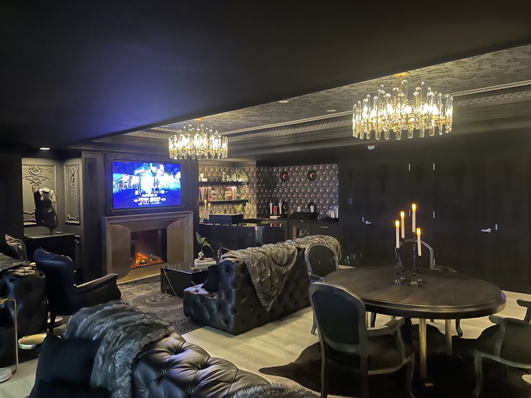 VIP arena luxury suite with crystal chandeliers, electric fireplace, tufted leather seating, and custom bar area — electrical work by Burlingame Brothers Electric